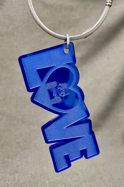 LOVE car charm in blue with the O; shaped like a heart featuring a Jeep inside, with tires touching the heart&#39;s sides.