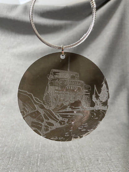 Jeep-inspired Adventure car charm hanging on a smoke gray background, river bed engraving highlights.